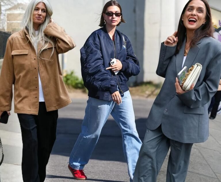 Women wearing trendy street style fashion outfits including oversized jackets, denim jeans, and casual urban accessories.