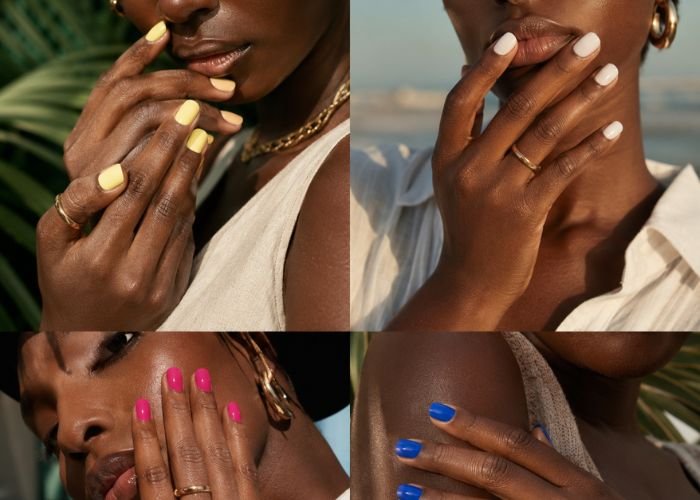 Short nails with butter yellow, milky white, hot pink, and cobalt blue polish on dark skin tones